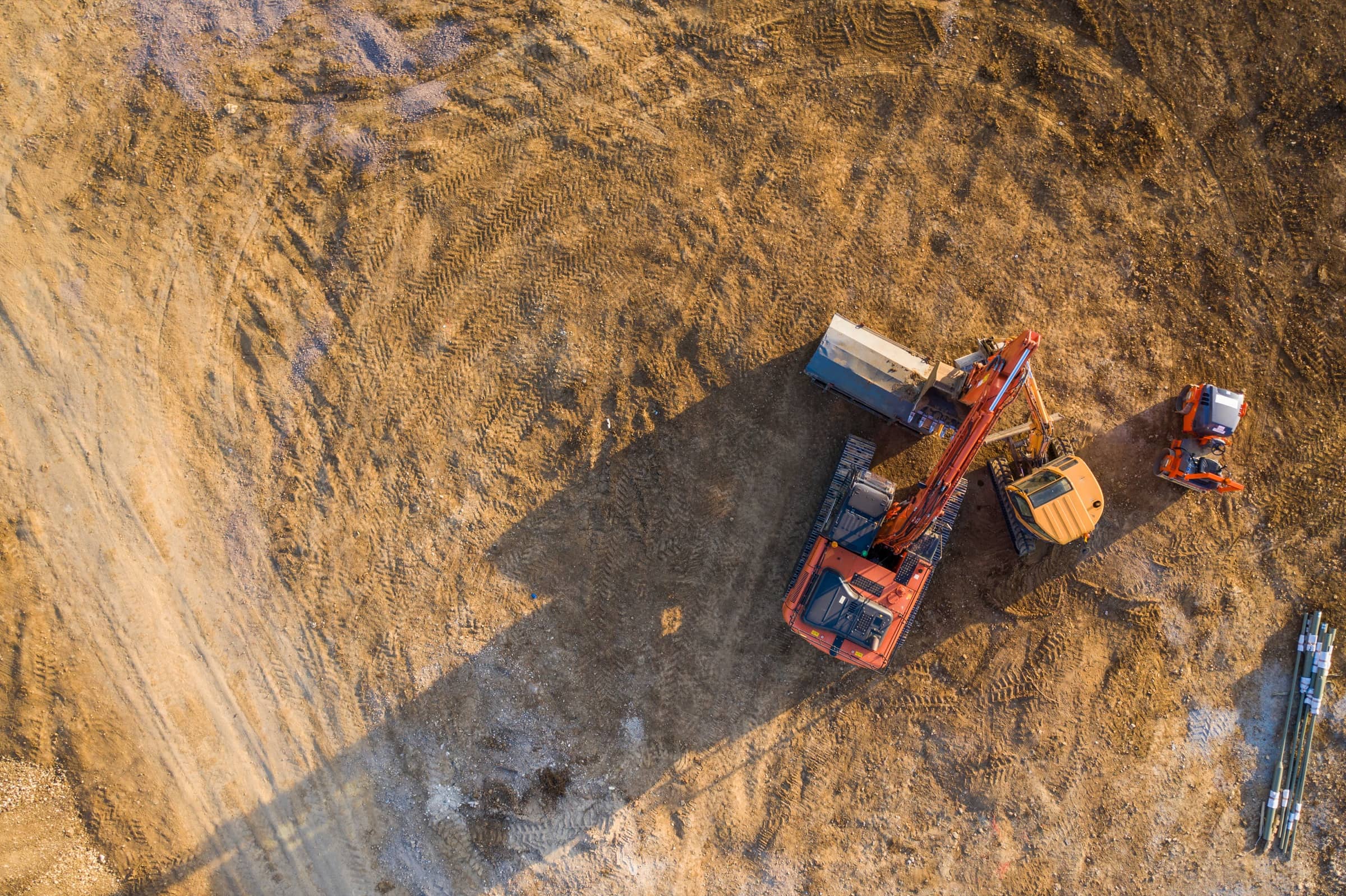 Aerial view of a construction site with trucks and earthmoving equipment
